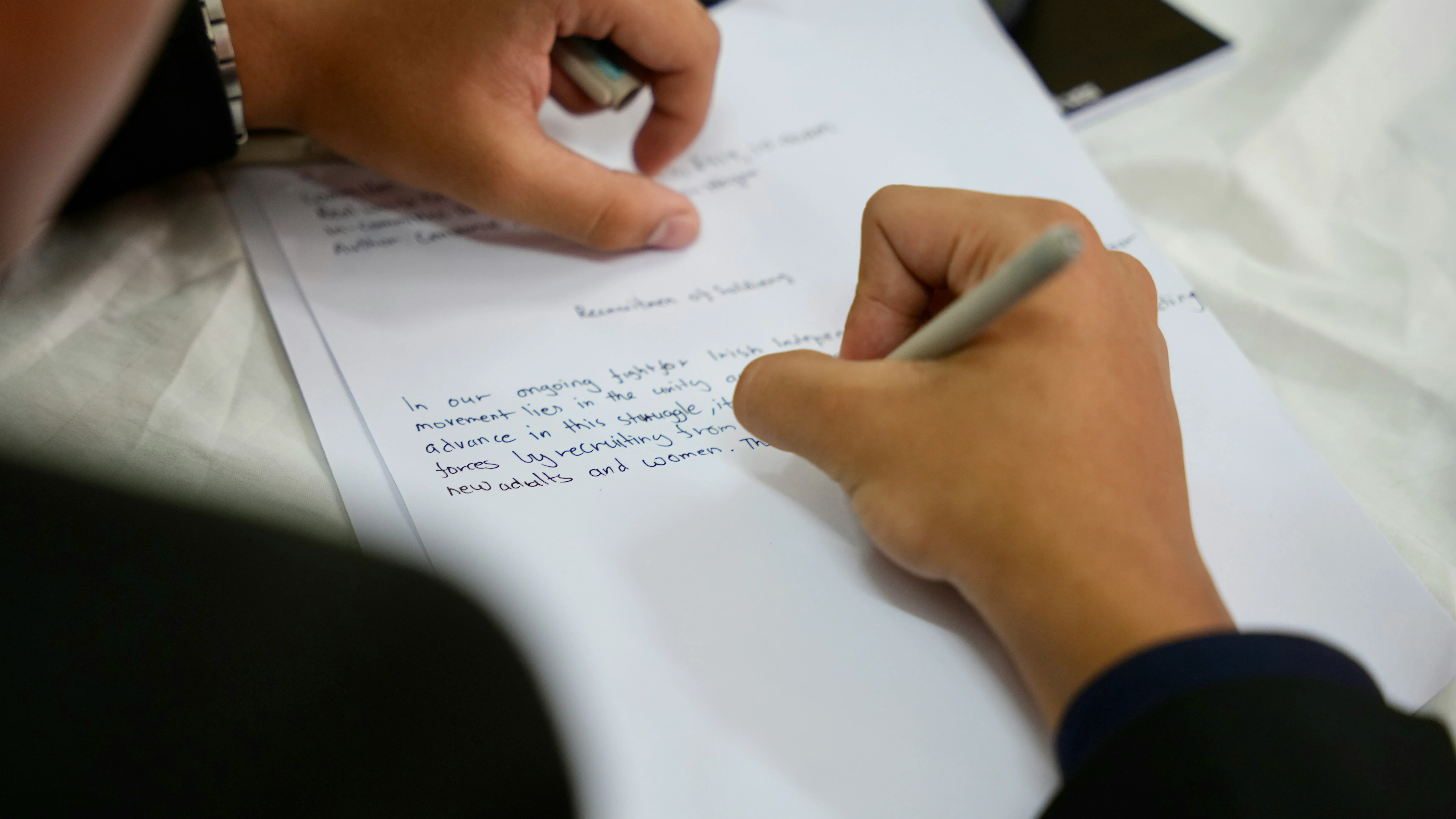 Student writing in notebook